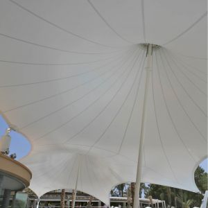 The membrane is fastened onto the building façade, and is designed towards the pool, where it is att